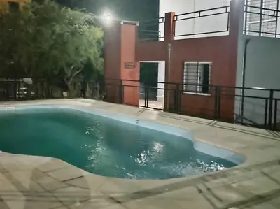 a swimming pool in front of a house at Cabaña Sombra Lunar en Cabañas Encuentro in Carpintería