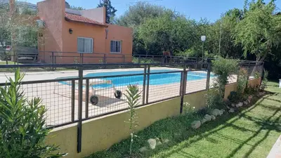 a fence around a swimming pool in a yard at Cabaña Sombra Lunar en Cabañas Encuentro in Carpintería