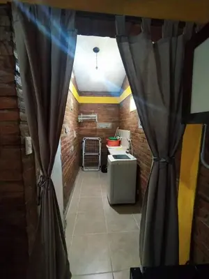 a room with a curtain in a room with a desk at Alojamiento temporal mis seis soles in Villa de Las Rosas