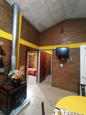 a room with a living room with a television and a room with a bedroom at Alojamiento temporal mis seis soles in Villa de Las Rosas