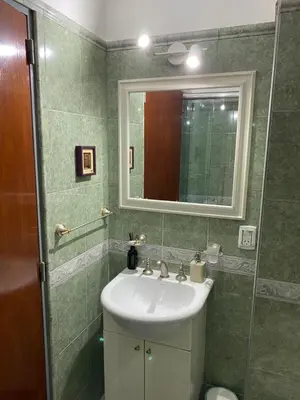 a bathroom with a sink and a mirror at Departamento temporario Colon y Fragueiro in Cordoba
