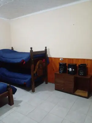 a room with two bunk beds and a table at Karylago11 in San Roque
