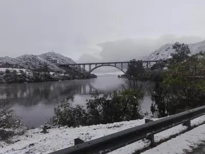 a bridge over a river with snow on the ground at Karylago11 in San Roque