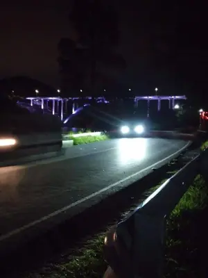 a car driving down a street at night at Karylago11 in San Roque