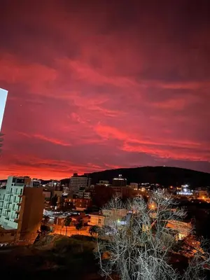 a red sky over a city at night at Departamento en Paseo Quatro in Villa Carlos Paz