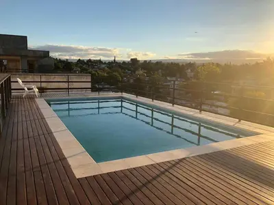 a swimming pool on the roof of a building at Departamento en Paseo Quatro in Villa Carlos Paz