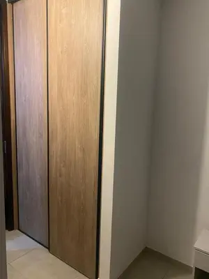 a closet with a wooden door in a room at Departamento en Paseo Quatro in Villa Carlos Paz