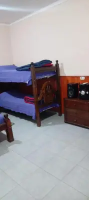 a bedroom with a bed and a wooden dresser at Karylago in Casa Bamba