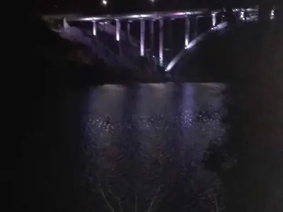 a bridge over a body of water at night at Karylago in Casa Bamba