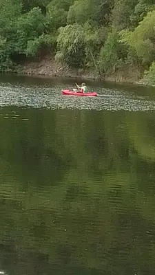 a person in a red boat on a lake at Karylago in Casa Bamba