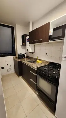 a kitchen with a stove and a counter top at Departamento -Buenos Aires- Pleno Nueva Cordoba By Apartcba in Cordoba