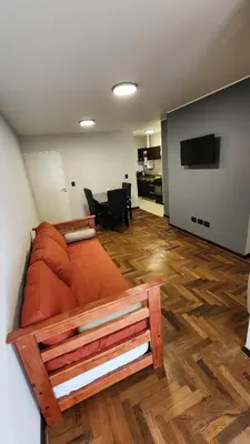 a bedroom with a bed and a living room at Departamento -Buenos Aires- Pleno Nueva Cordoba By Apartcba in Cordoba