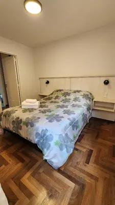 a bedroom with a bed and a wooden floor at Departamento -Buenos Aires- Pleno Nueva Cordoba By Apartcba in Cordoba