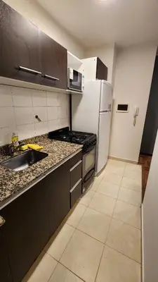 a kitchen with a white refrigerator and a sink at Departamento -Buenos Aires- Pleno Nueva Cordoba By Apartcba in Cordoba