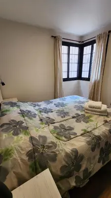 a bedroom with a bed with a floral comforter at Departamento -Buenos Aires- Pleno Nueva Cordoba By Apartcba in Cordoba