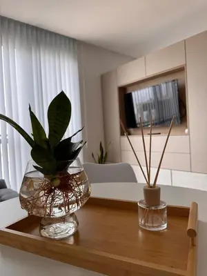 two vases sitting on a wooden table in a living room at Bahía 108 Apart Premium in Villa Carlos Paz