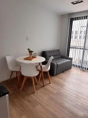 a living room with a table and chairs and a couch at Bahía 108 Apart Premium in Villa Carlos Paz