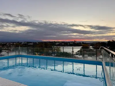 a swimming pool on the roof of a building at Bahía 108 Apart Premium in Villa Carlos Paz