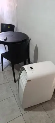 a table and a table and a chair and a machine at Celeste departamento in Cordoba