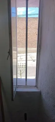 an open door with a view of a window at Celeste departamento in Cordoba