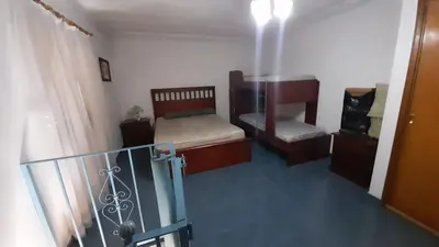 a small room with two beds and a balcony at Las Crasas in Alta Gracia