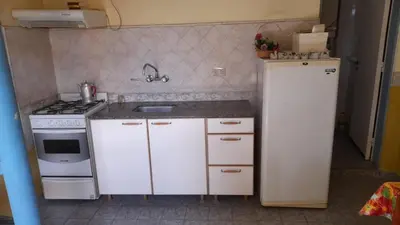 a small kitchen with a sink and a stove at Las Crasas in Alta Gracia