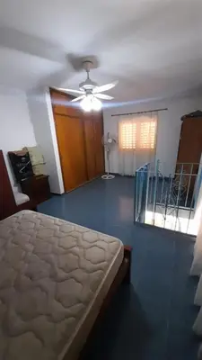 a bedroom with a bed and a ceiling fan at Las Crasas in Alta Gracia