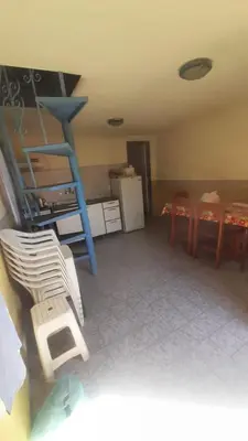 a living room with a blue ladder and a table at Las Crasas in Alta Gracia