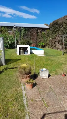 a yard with potted plants and a swimming pool at Las Crasas in Alta Gracia