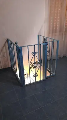 a staircase with a glass railing with a candle at Las Crasas in Alta Gracia