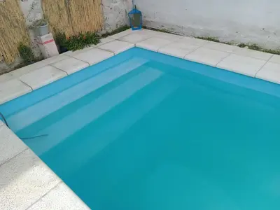 a swimming pool with blue water at Sol y rio in Villa Carlos Paz