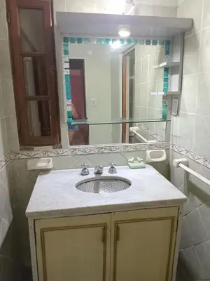 a bathroom with a sink and a large mirror at Sol y rio in Villa Carlos Paz