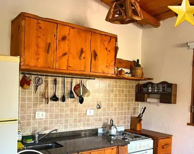 a kitchen with a sink and a stove top oven at das gelbe haus in Los Reartes