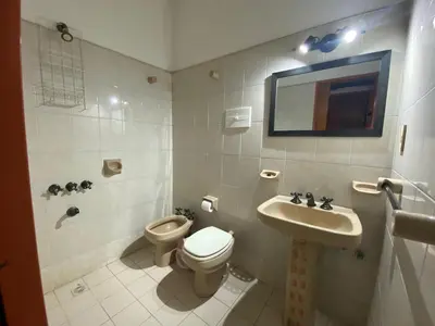 a bathroom with a toilet and a sink at Chalet Pino azul in Villa Carlos Paz