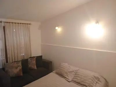 a bedroom with a bed and a couch at Chalet Pino azul in Villa Carlos Paz