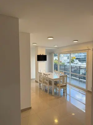 a kitchen and dining room with a table and chairs at Edificio Leonardo Villa Carlos Paz in Villa Carlos Paz
