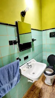 a bathroom with a sink and a toilet and a mirror at Casa en el Río in Alpa Corral