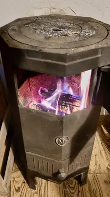a stove with a fire inside of it at Casa en el Río in Alpa Corral