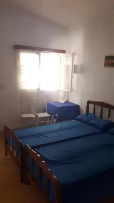 a bedroom with two beds and a window at Casa en el Río in Alpa Corral