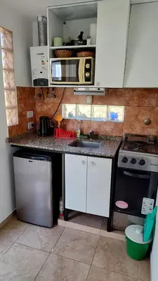 a kitchen with a sink and a stove top oven at Departamento con kitchenet con entrada independiente in Cordoba