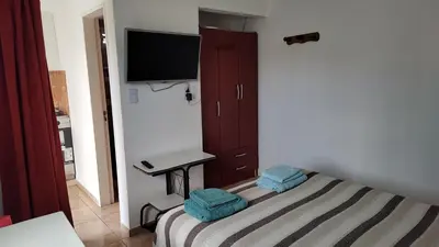 a bedroom with a bed with blue towels on it at Departamento con kitchenet con entrada independiente in Cordoba