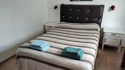 a bedroom with a bed with two towels on it at Departamento con kitchenet con entrada independiente in Cordoba