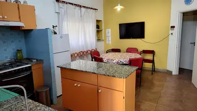 a small kitchen with a table and a kitchen with a table and chairs at Amplia casa cerca del centro de la ciudad in Cordoba