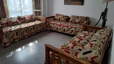 a living room with two couches and a couch at Amplia casa cerca del centro de la ciudad in Cordoba