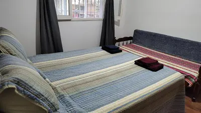 a bed with two pillows on it in a bedroom at Amplia casa cerca del centro de la ciudad in Cordoba