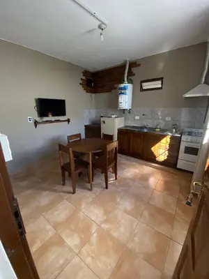 a kitchen with a table and chairs in a room at La moora in Alta Gracia