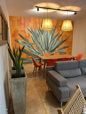 a living room with a large plant on the wall at Casa Frida - Alojamiento exclusivo para Mujeres - in Villa Carlos Paz