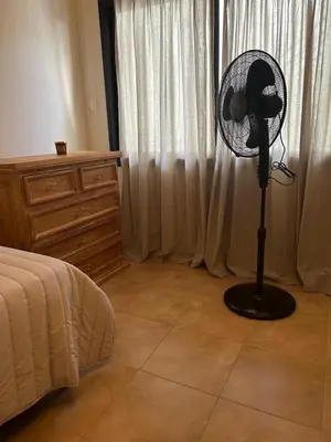 a bedroom with a fan next to a bed at Casa Frida - Alojamiento exclusivo para Mujeres - in Villa Carlos Paz