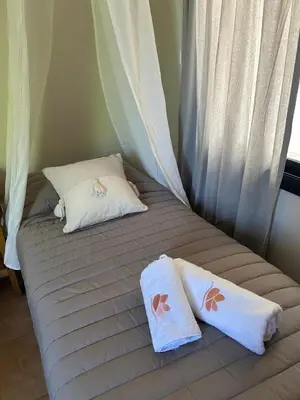 a bed with two towels on top of it at Casa Frida - Alojamiento exclusivo para Mujeres - in Villa Carlos Paz