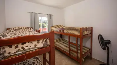 two bunk beds in a room with a window at Cabaña El Candil Solo Familias in Villa Carlos Paz